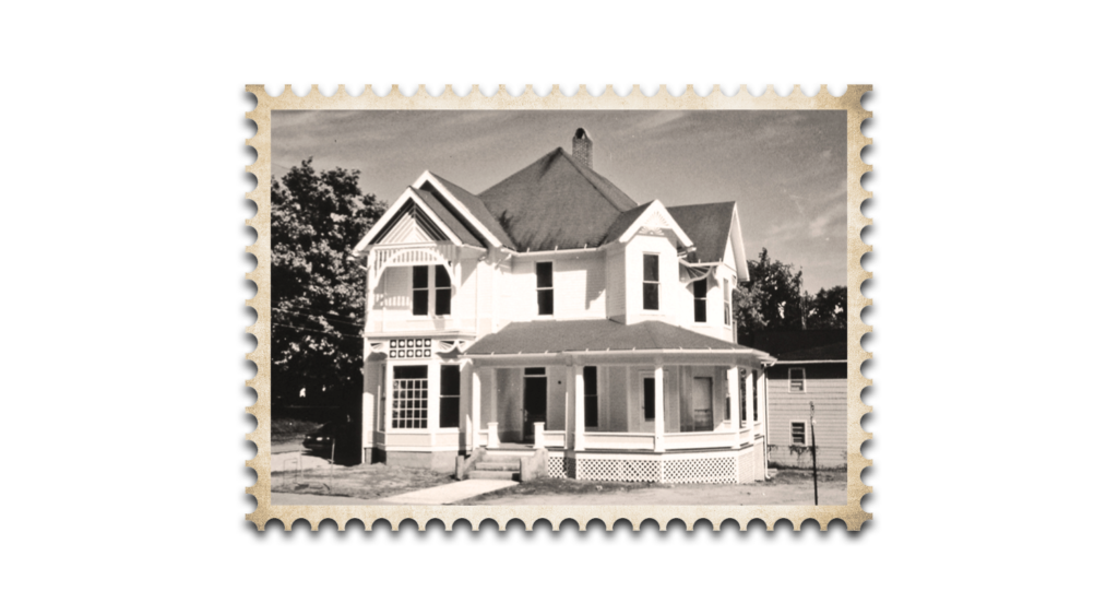 black and white stamp graphic of front of house from street